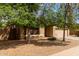 Single story home with desert landscaping and mature shade trees at 2590 S Buckaroo Trl, Gilbert, AZ 85295