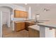 Kitchen featuring wood cabinets, neutral countertops, and stainless-steel appliances at 2590 S Buckaroo Trl, Gilbert, AZ 85295