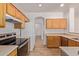 Kitchen featuring wood cabinets and stainless-steel appliances at 2590 S Buckaroo Trl, Gilbert, AZ 85295
