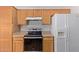 Well-equipped kitchen with wood cabinets and stainless-steel appliances at 2590 S Buckaroo Trl, Gilbert, AZ 85295