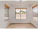 Bright, neutral living room with wood-look floors and large windows offering a view at 2590 S Buckaroo Trl, Gilbert, AZ 85295