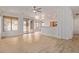 Open concept living room with wood floors, a ceiling fan, and sliding door access to the backyard at 2590 S Buckaroo Trl, Gilbert, AZ 85295