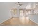 Open concept living room showcasing modern ceiling fan, wood floors, and backyard access at 2590 S Buckaroo Trl, Gilbert, AZ 85295