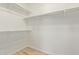 A simple walk-in closet features built-in shelving and wood-look flooring, ideal for easy organization at 2590 S Buckaroo Trl, Gilbert, AZ 85295