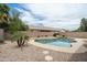 Lush backyard featuring a private pool with rock accents and mature landscaping at 2834 E Devon Ct, Gilbert, AZ 85296