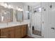 Bright bathroom featuring a double vanity with modern fixtures and a separate tiled shower with a glass door at 2834 E Devon Ct, Gilbert, AZ 85296