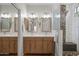 Bright bathroom featuring a double vanity with modern fixtures and a separate tiled shower with a glass door at 2834 E Devon Ct, Gilbert, AZ 85296