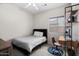 Simple bedroom featuring a bed, desk, and a window providing natural light at 2834 E Devon Ct, Gilbert, AZ 85296