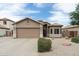 Charming single-story home with manicured landscaping, neutral stucco, and a two-car garage at 2834 E Devon Ct, Gilbert, AZ 85296