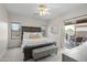 Warm and inviting main bedroom features a ceiling fan, patio access, and stylish decor at 2834 E Devon Ct, Gilbert, AZ 85296