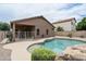 Inviting backyard pool with rock features and patio, perfect for outdoor enjoyment at 2834 E Devon Ct, Gilbert, AZ 85296