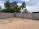 Spacious dirt backyard enclosed by a tall block wall at 3102 N Woodburne Dr, Chandler, AZ 85224