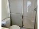 Bathroom shower with glass doors and integrated bench and toilet at 3102 N Woodburne Dr, Chandler, AZ 85224