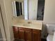 Bathroom vanity featuring a wooden cabinet, sink, and a mirror with medicine cabinet at 3102 N Woodburne Dr, Chandler, AZ 85224