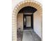 Inviting arched entryway with brick and stucco accents, leading to a white front door at 3102 N Woodburne Dr, Chandler, AZ 85224