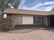 Exterior view featuring a low-rise house with a brown roof and well-maintained landscaping at 3102 N Woodburne Dr, Chandler, AZ 85224