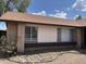Charming single-story home exterior with brick accents, rock landscaping and blue skies at 3102 N Woodburne Dr, Chandler, AZ 85224