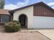 Inviting single-Gathering home featuring an arched entryway and attached two-car garage at 3102 N Woodburne Dr, Chandler, AZ 85224