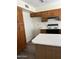 Kitchen featuring wood cabinets, white countertops, and an island with breakfast bar seating at 3102 N Woodburne Dr, Chandler, AZ 85224
