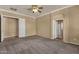 Spacious bedroom with carpet, neutral walls, and open closet, perfect for relaxation and personalization at 34944 N Mirandesa Dr, San Tan Valley, AZ 85143