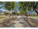 Tree-lined walking paths leading to playgrounds and picnic areas in a Gathering-friendly community park at 34944 N Mirandesa Dr, San Tan Valley, AZ 85143
