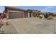 Wide driveway leading to a well-maintained home with desert landscaping in a quiet neighborhood at 34944 N Mirandesa Dr, San Tan Valley, AZ 85143
