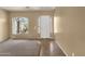 Bright entryway with neutral walls and tile flooring, leading into carpeted living space at 34944 N Mirandesa Dr, San Tan Valley, AZ 85143