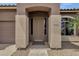 Inviting front entryway with a covered porch and decorative columns enhancing curb appeal at 34944 N Mirandesa Dr, San Tan Valley, AZ 85143