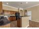 Bright eat-in kitchen with granite countertops and center island with stainless steel sink at 34944 N Mirandesa Dr, San Tan Valley, AZ 85143