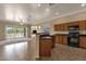 Open kitchen featuring ample cabinets, granite counters and seamless flow to the backyard and living room at 34944 N Mirandesa Dr, San Tan Valley, AZ 85143