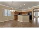 Open floorplan shows kitchen with breakfast bar and dining area with hanging chandelier at 34944 N Mirandesa Dr, San Tan Valley, AZ 85143