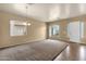 Spacious living room featuring neutral walls, carpet flooring, and lots of natural light at 34944 N Mirandesa Dr, San Tan Valley, AZ 85143