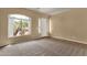 Neutral living room with carpet and tile accents, with bright windows at 34944 N Mirandesa Dr, San Tan Valley, AZ 85143