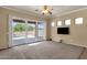 Bright living room with access to backyard pool through large sliding glass doors at 34944 N Mirandesa Dr, San Tan Valley, AZ 85143