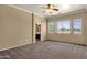 Large main bedroom features ensuite bathroom access and outside view of neighborhood at 34944 N Mirandesa Dr, San Tan Valley, AZ 85143