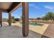 Relaxing poolside view with ample patio space and desert landscape beyond at 34944 N Mirandesa Dr, San Tan Valley, AZ 85143