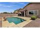 Beautiful pool with a view of a covered patio and manicured landscaping in the backyard at 34944 N Mirandesa Dr, San Tan Valley, AZ 85143