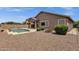 Inviting pool area with desert landscaping and a covered patio for outdoor living at 34944 N Mirandesa Dr, San Tan Valley, AZ 85143