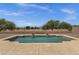Sparkling pool with rock landscaping and wrought iron fence creating a backyard retreat at 34944 N Mirandesa Dr, San Tan Valley, AZ 85143
