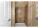 A tiled shower with a shower head and a convenient built-in niche for storage at 34944 N Mirandesa Dr, San Tan Valley, AZ 85143