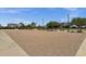 Sand volleyball court surrounded by lush trees and landscaping in the Circle Cross Ranch community at 34944 N Mirandesa Dr, San Tan Valley, AZ 85143