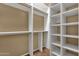 Spacious walk-in closet with ample shelving, providing plenty of room for organization at 34944 N Mirandesa Dr, San Tan Valley, AZ 85143