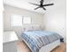 Bright bedroom with ceiling fan, light colored walls, and wood-look flooring at 35360 N 93Rd Way, Scottsdale, AZ 85262