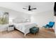 Bright bedroom featuring laminate flooring, a ceiling fan, and comfortable furnishings at 35360 N 93Rd Way, Scottsdale, AZ 85262