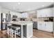 Modern kitchen featuring white cabinetry, stainless steel appliances, and a center island with seating at 35360 N 93Rd Way, Scottsdale, AZ 85262