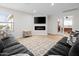 Cozy living room with modern fireplace, large sectional sofa, and neutral color palette at 35360 N 93Rd Way, Scottsdale, AZ 85262