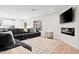 Open living room with stylish decor, including a modern fireplace and large sectional couch at 35360 N 93Rd Way, Scottsdale, AZ 85262