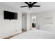 Spacious bedroom with a large TV, neutral walls, and an open ensuite bathroom at 35360 N 93Rd Way, Scottsdale, AZ 85262