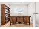 Office space with built-in shelving and large wooden desk at 35360 N 93Rd Way, Scottsdale, AZ 85262