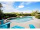 Inviting pool area surrounded by mature landscaping and bright blue lounge chairs at 35360 N 93Rd Way, Scottsdale, AZ 85262